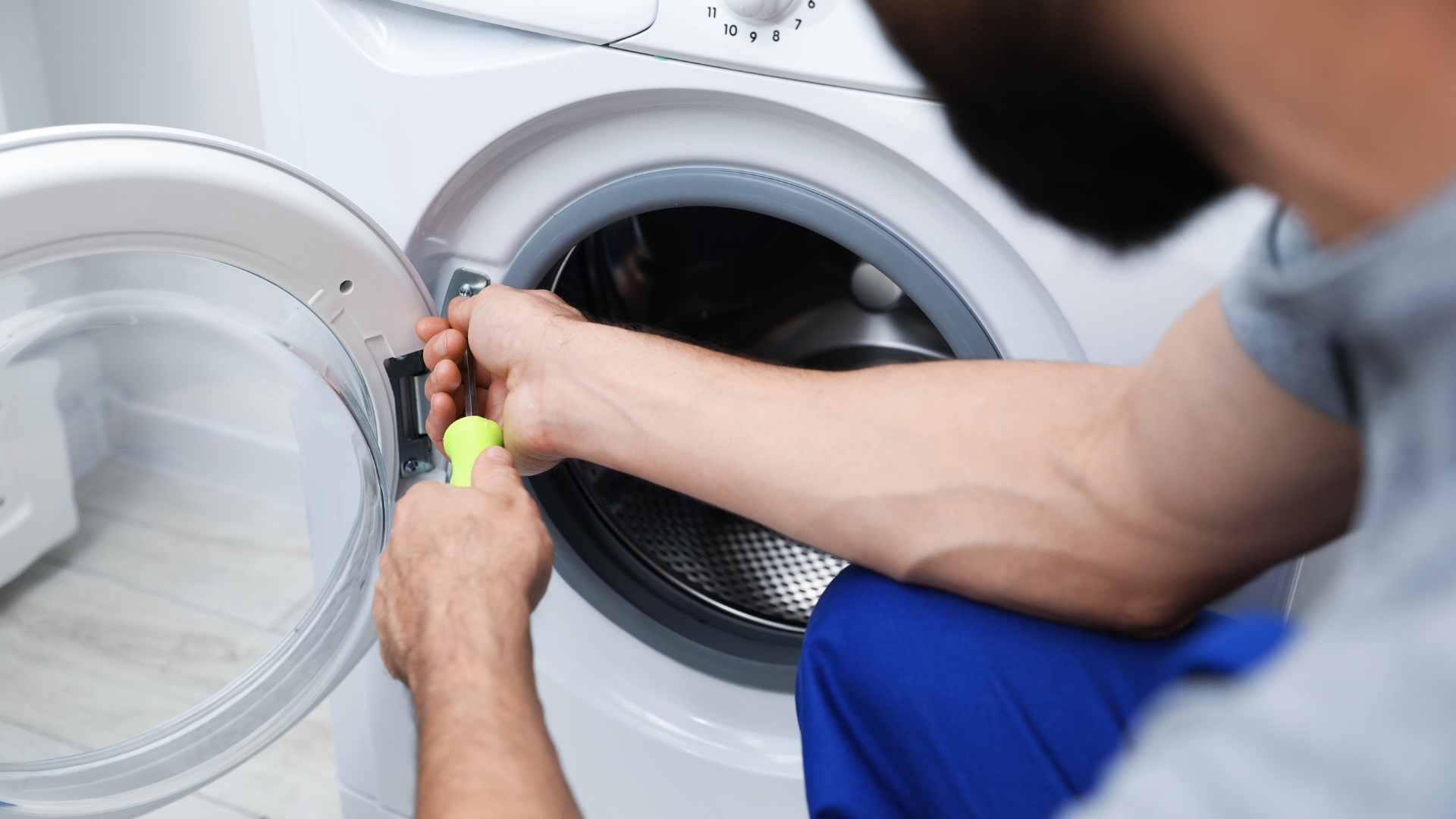 Industrial laundry room with large front-loading washers and dryers in a utility area