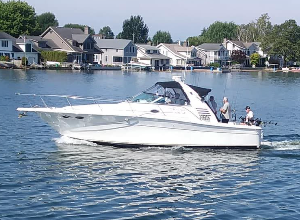 A white boat is floating on top of a body of water.