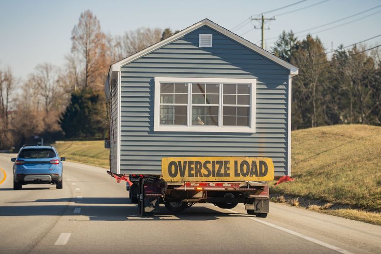 A small house on a trailer, labeled 