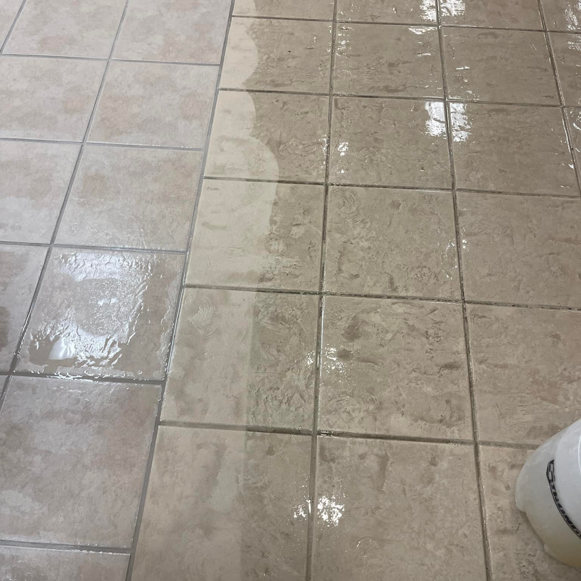 Robert's Cleaning and Restoration - A dirty tile floor with a white bowl on it