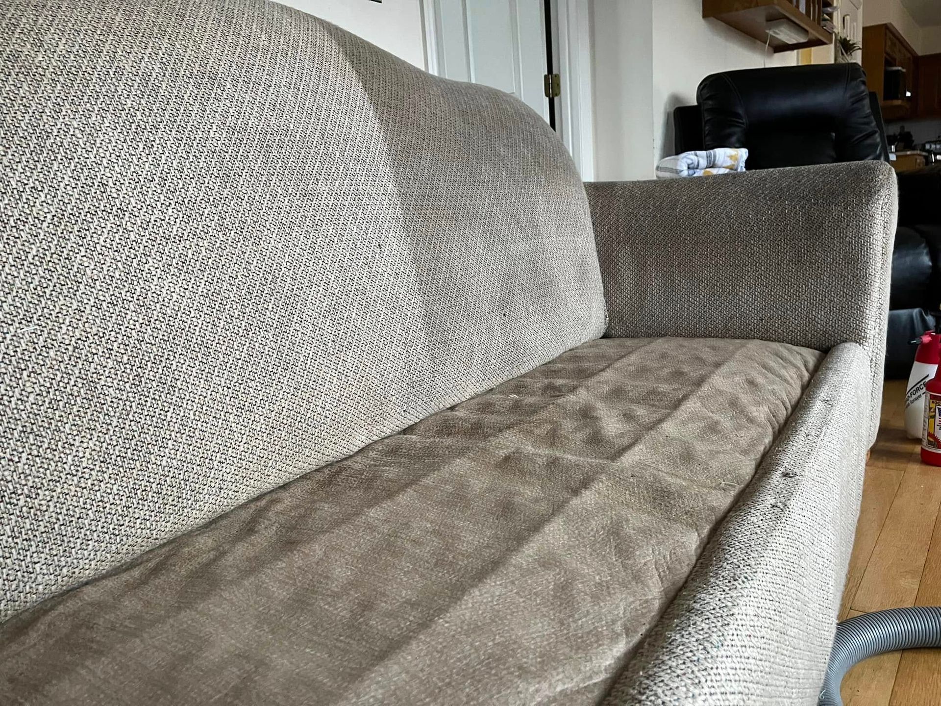 Robert's Cleaning and Restoration - A couch with a blanket on it in a living room.