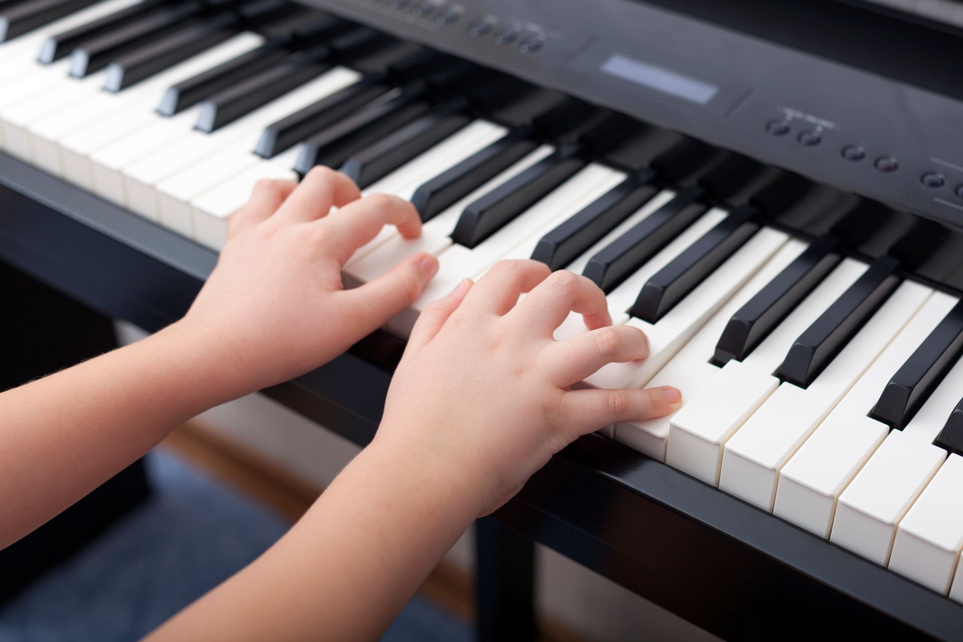 child learning the piano