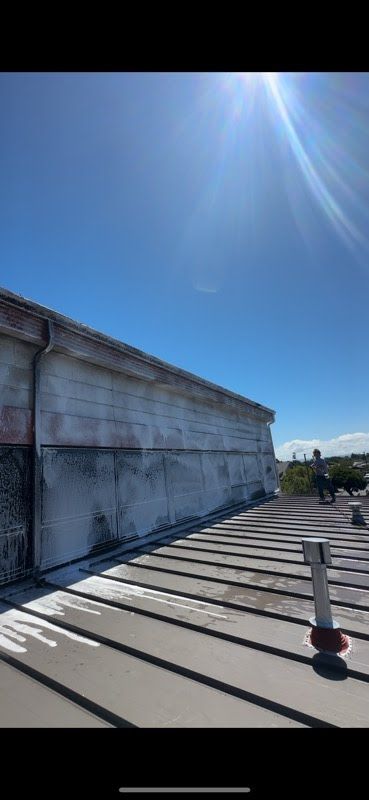 The sun is shining brightly on the roof of a building.