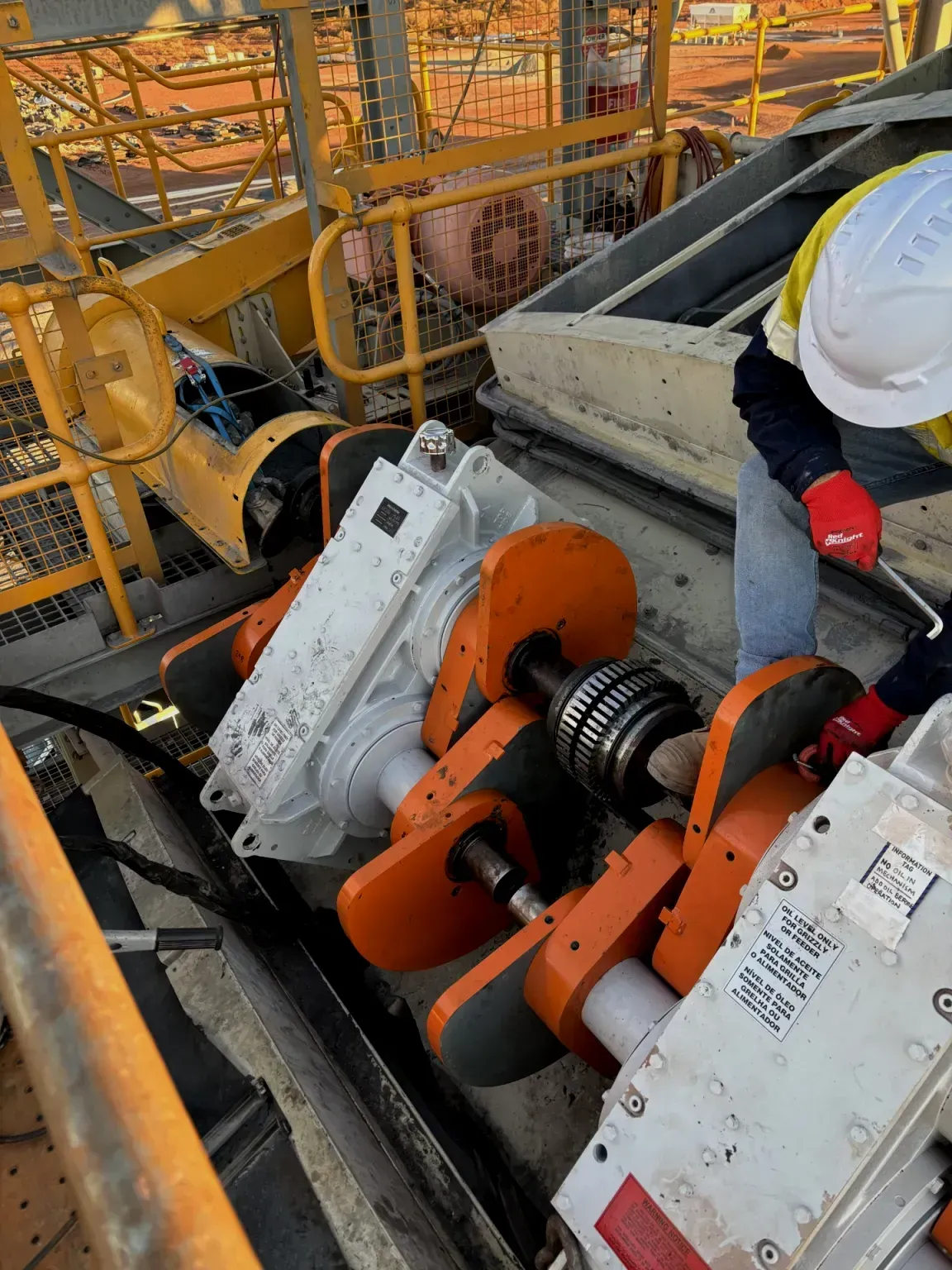 A man in a hard hat is working on a machine.