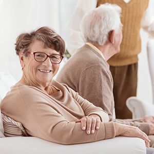 Elderly Man And Woman Sitting On A Couch