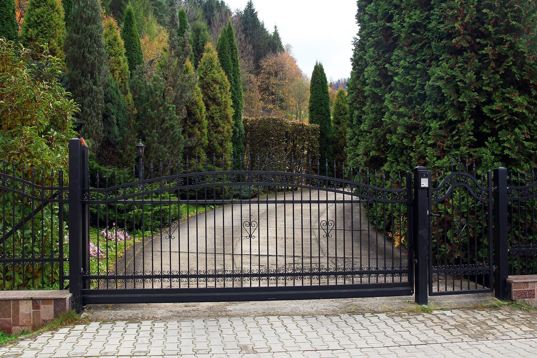 black wrought gate property garden background