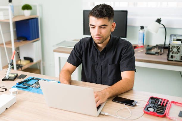 A person using his device after a laptop repair