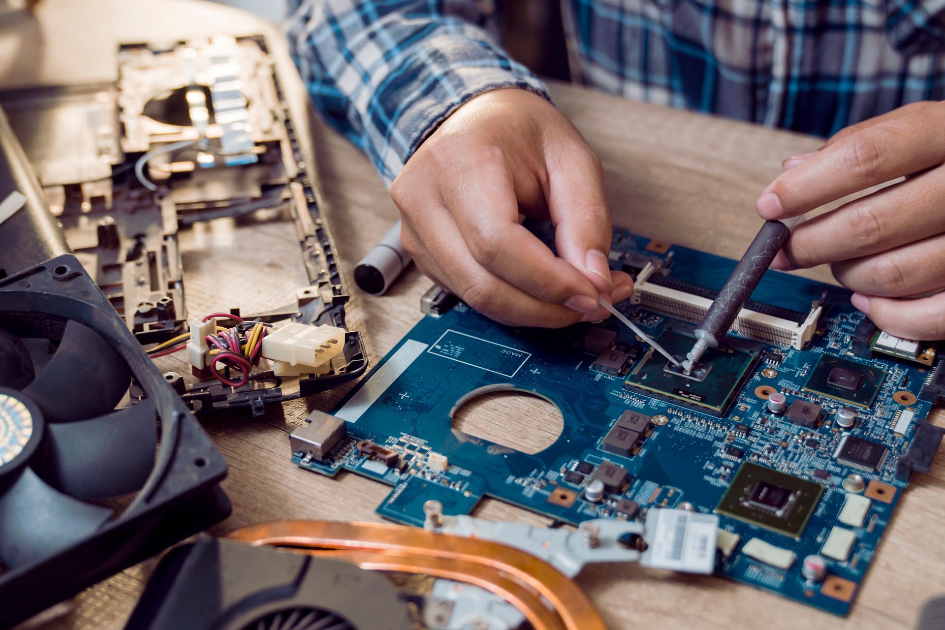 Close up of a man soldering computer chip.