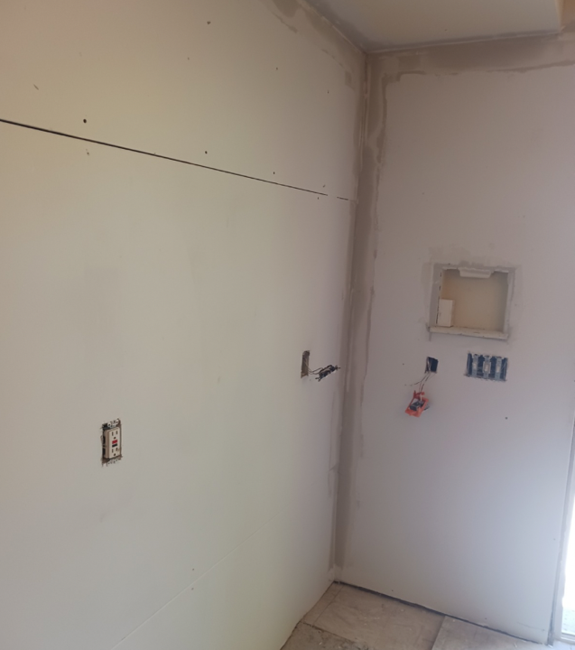 A close up of a white ceiling in a room with wooden floors.