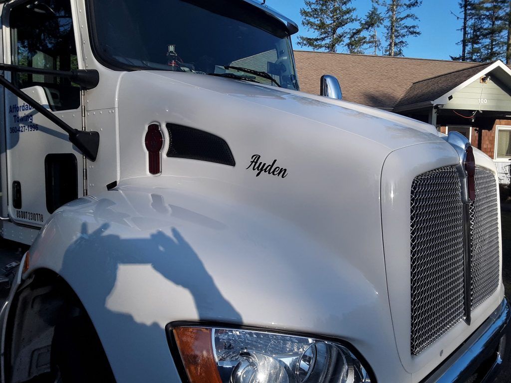 A white truck with the name ayden on the hood