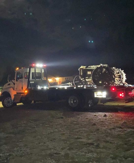 A tow truck with a motorcycle on the back of it