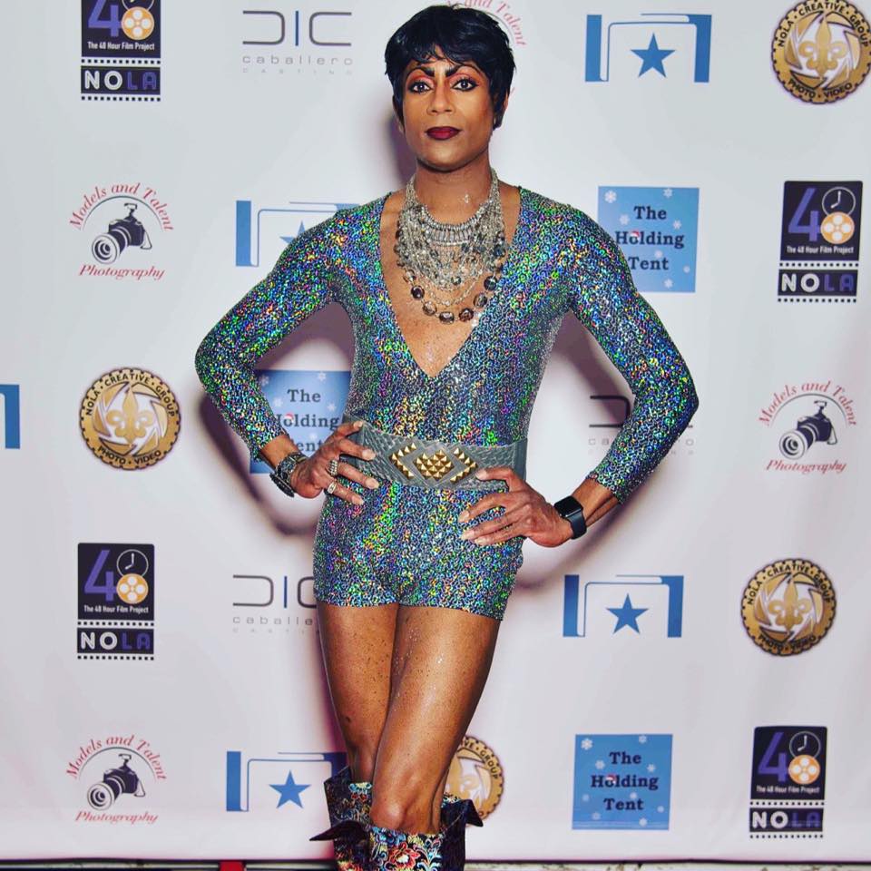 A woman is standing in front of a backdrop that says the holding test