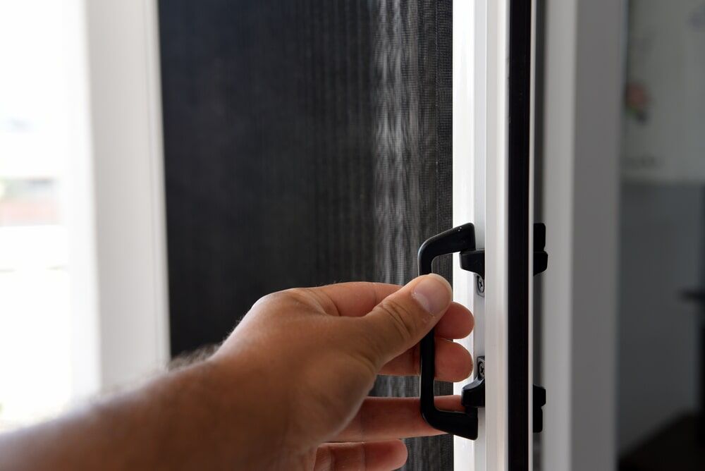 Person Opening Sliding Door — Glass & Aluminium in Smithfield, QLD