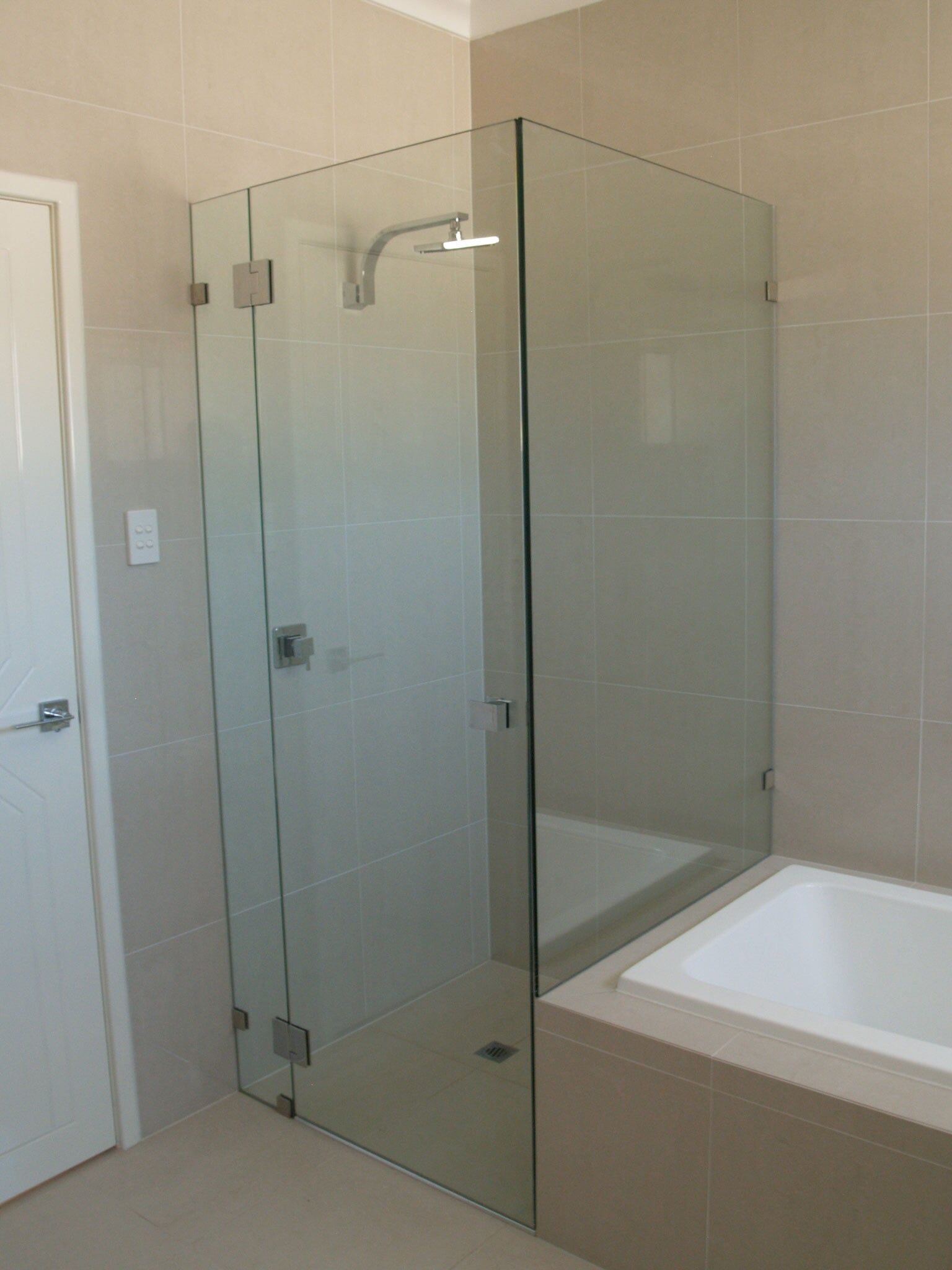 Glass Shower Next to Bath Tub — Glass & Aluminium in Smithfield, QLD