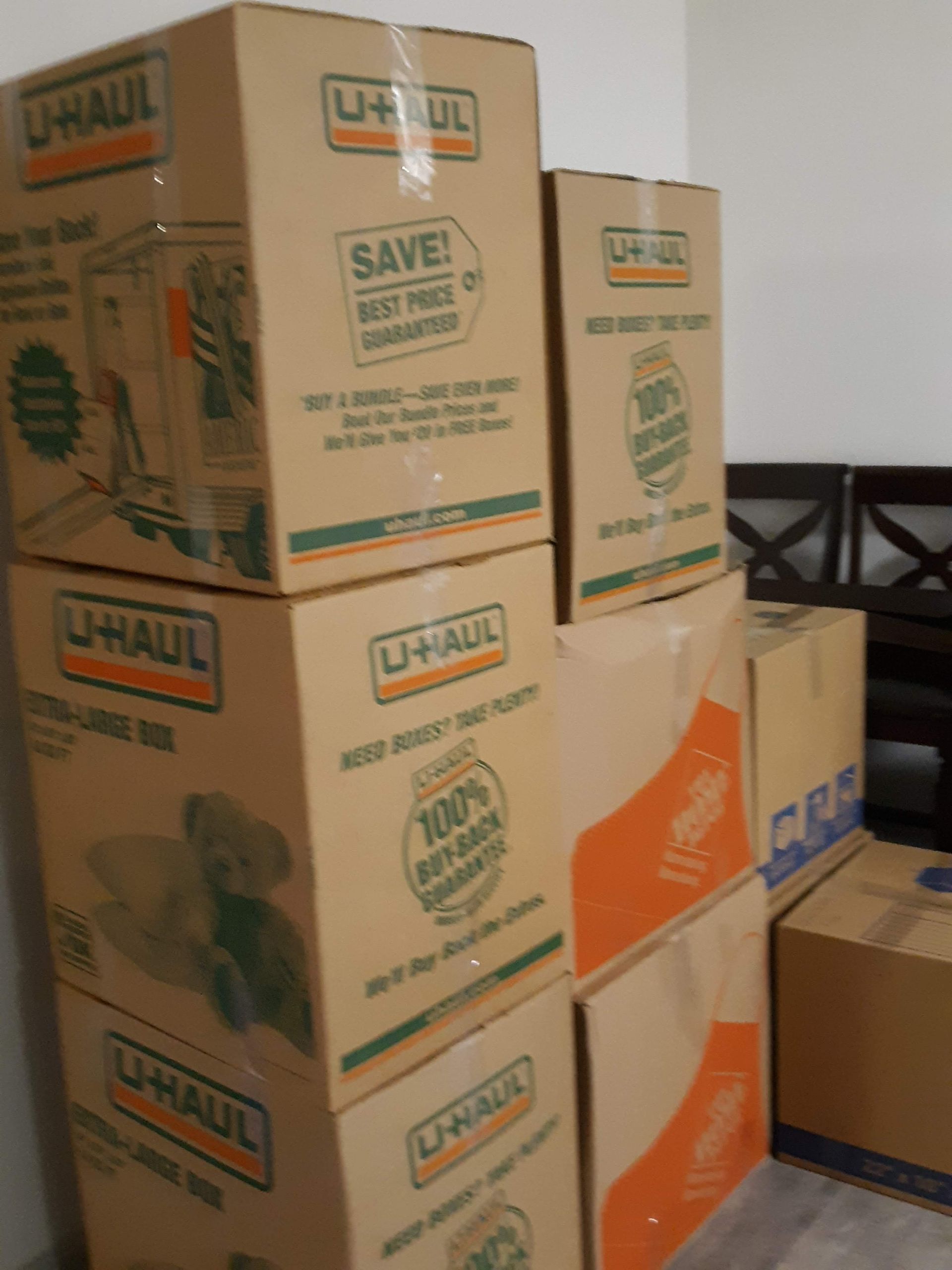 A bunch of cardboard boxes are stacked on top of each other in a room.