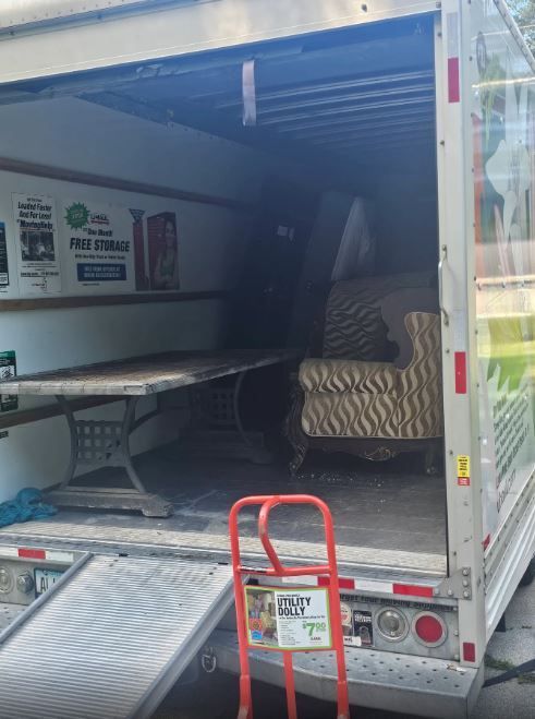 The back of a moving truck with the door open