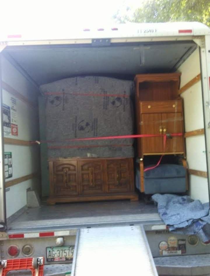 The back of a moving truck with a sign that says ' phoenix ' on it