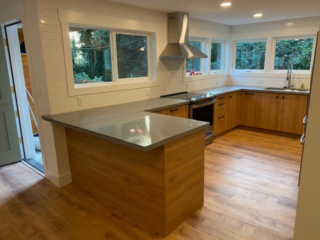 Modern kitchen remodel with white shaker cabinets and quartz island