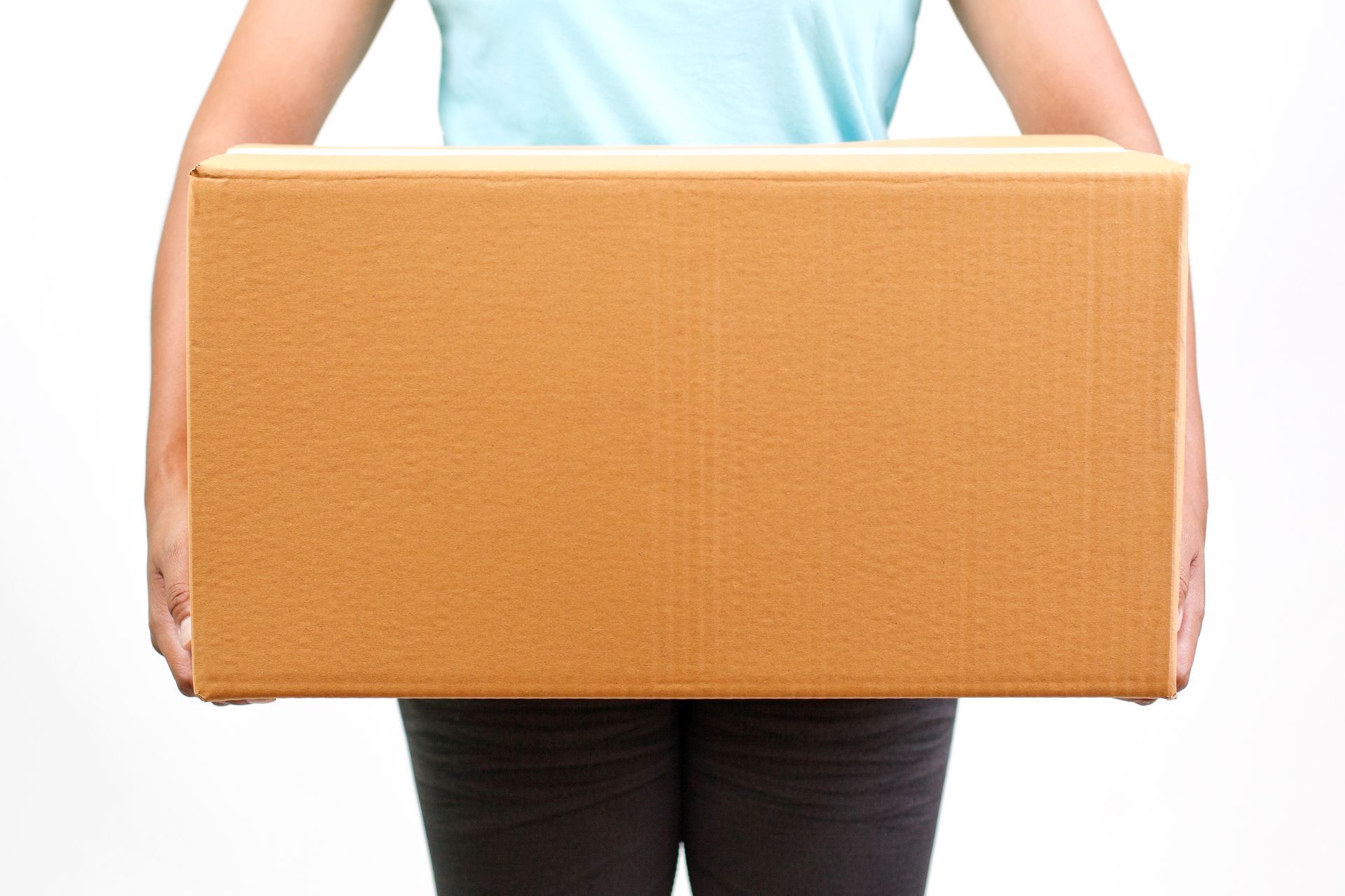 Person holding a large cardboard box against a white background.