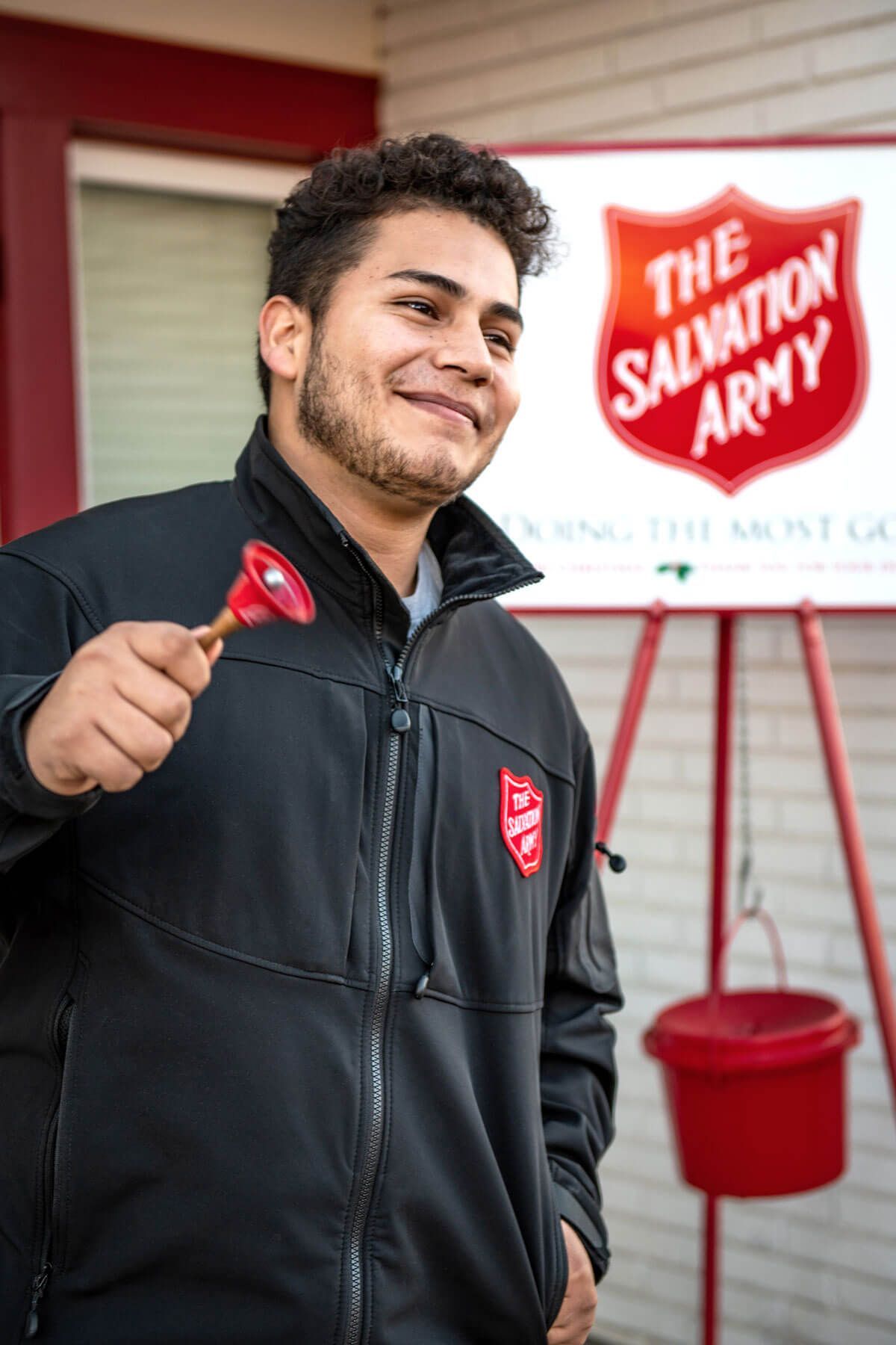 young man ringing bell for charity