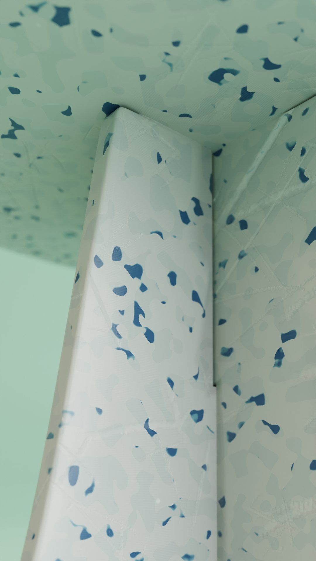 A corner of a wall with blue spots on it