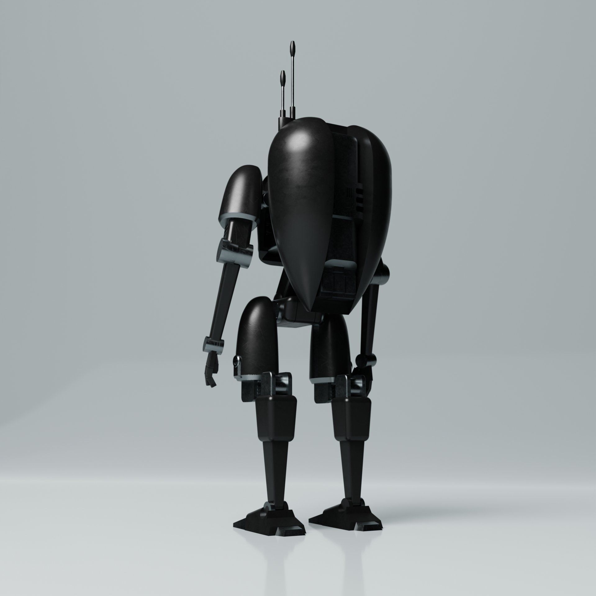 A black robot is standing on a white surface