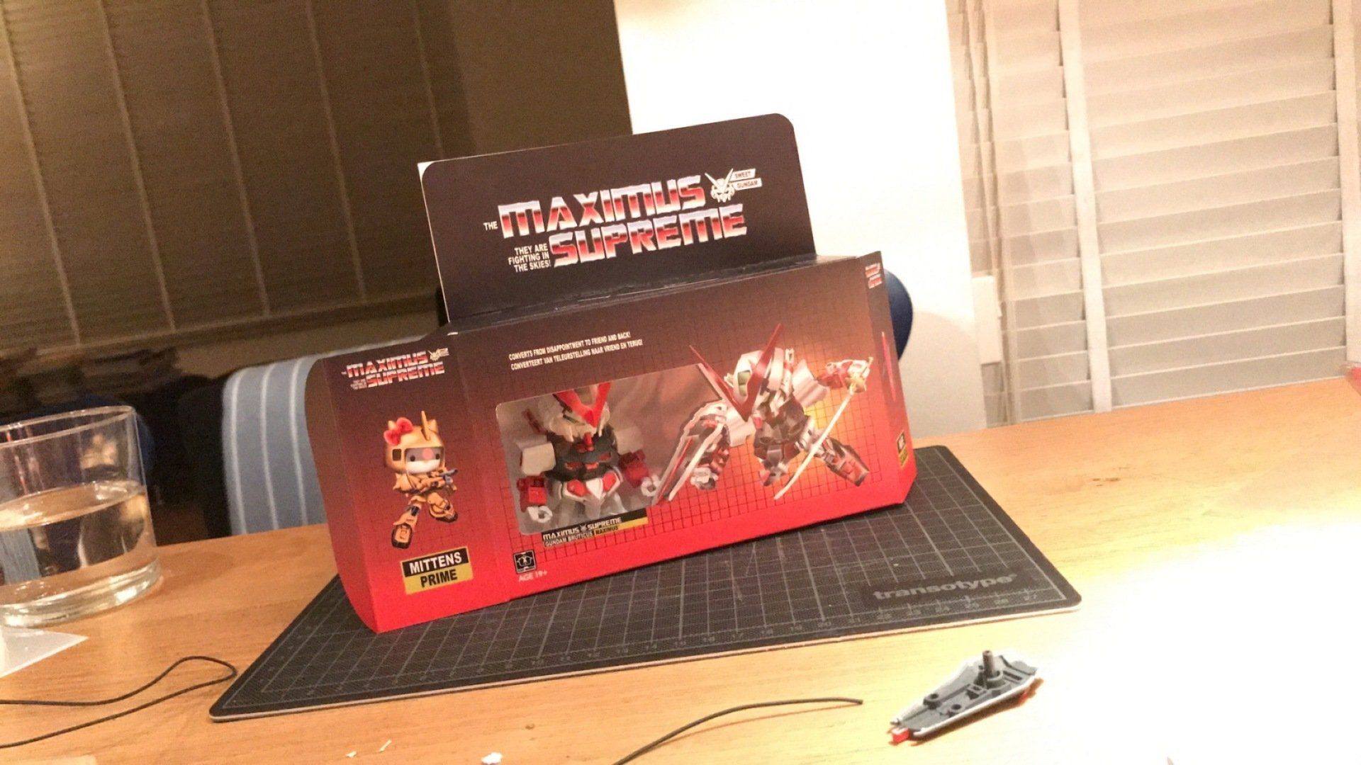 A box that says ' Maximus Supreme ' on it sits on a table