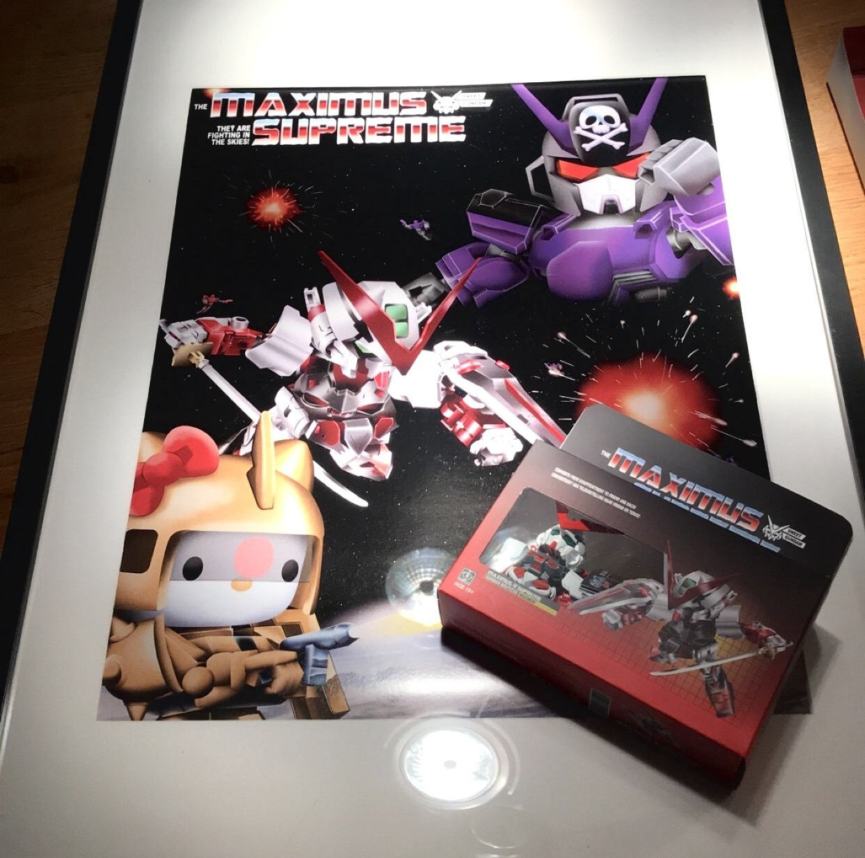 A poster of robots fighting in space next to a box that says maximus supreme