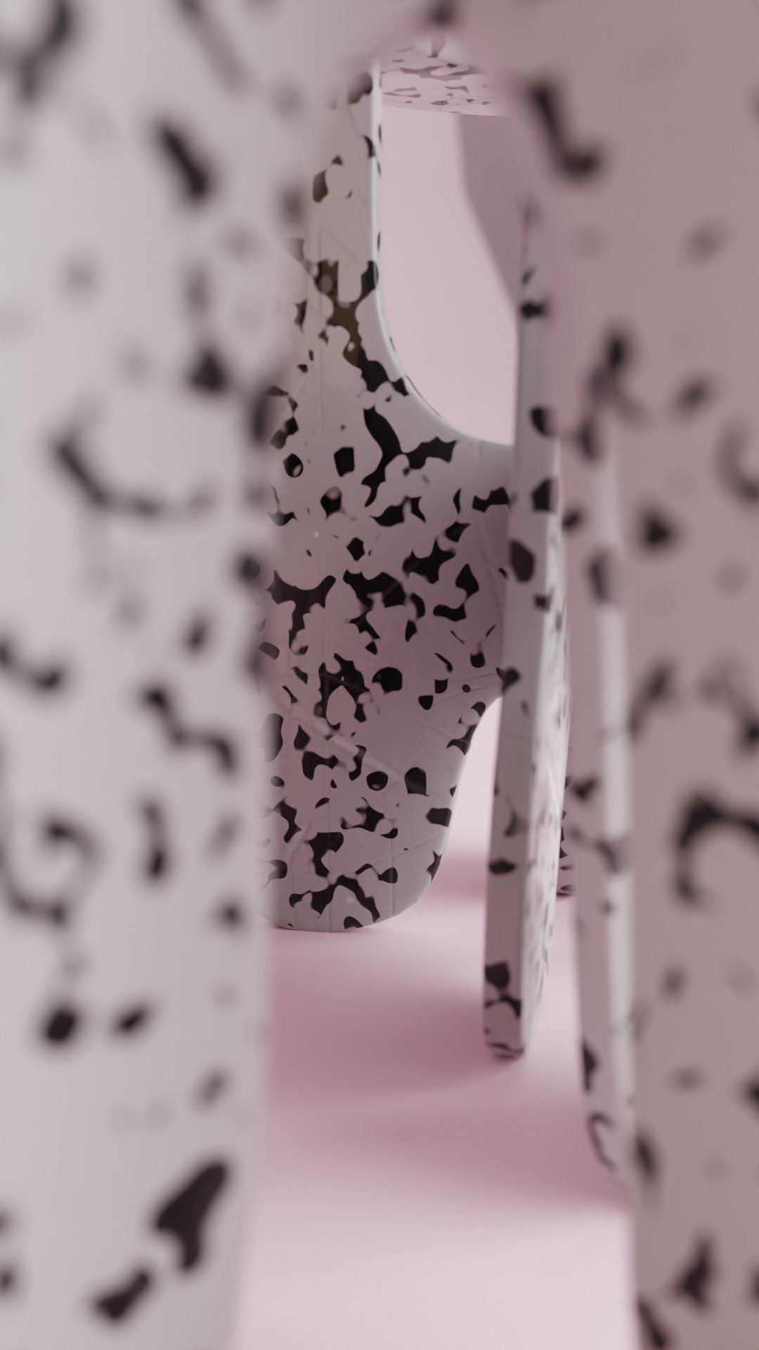 A pair of white high heels with black spots on them.