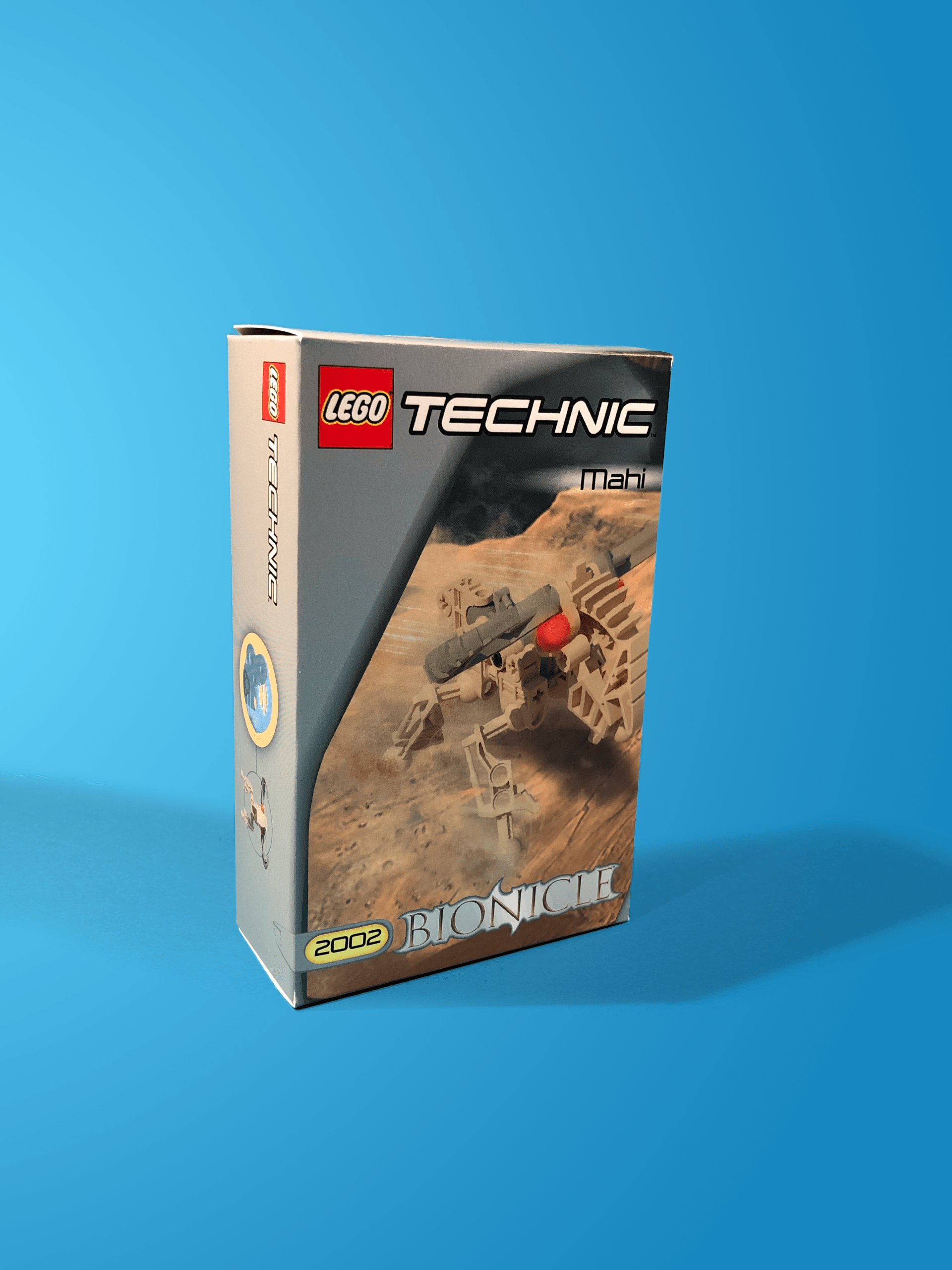 A lego technic box is sitting on a blue surface.