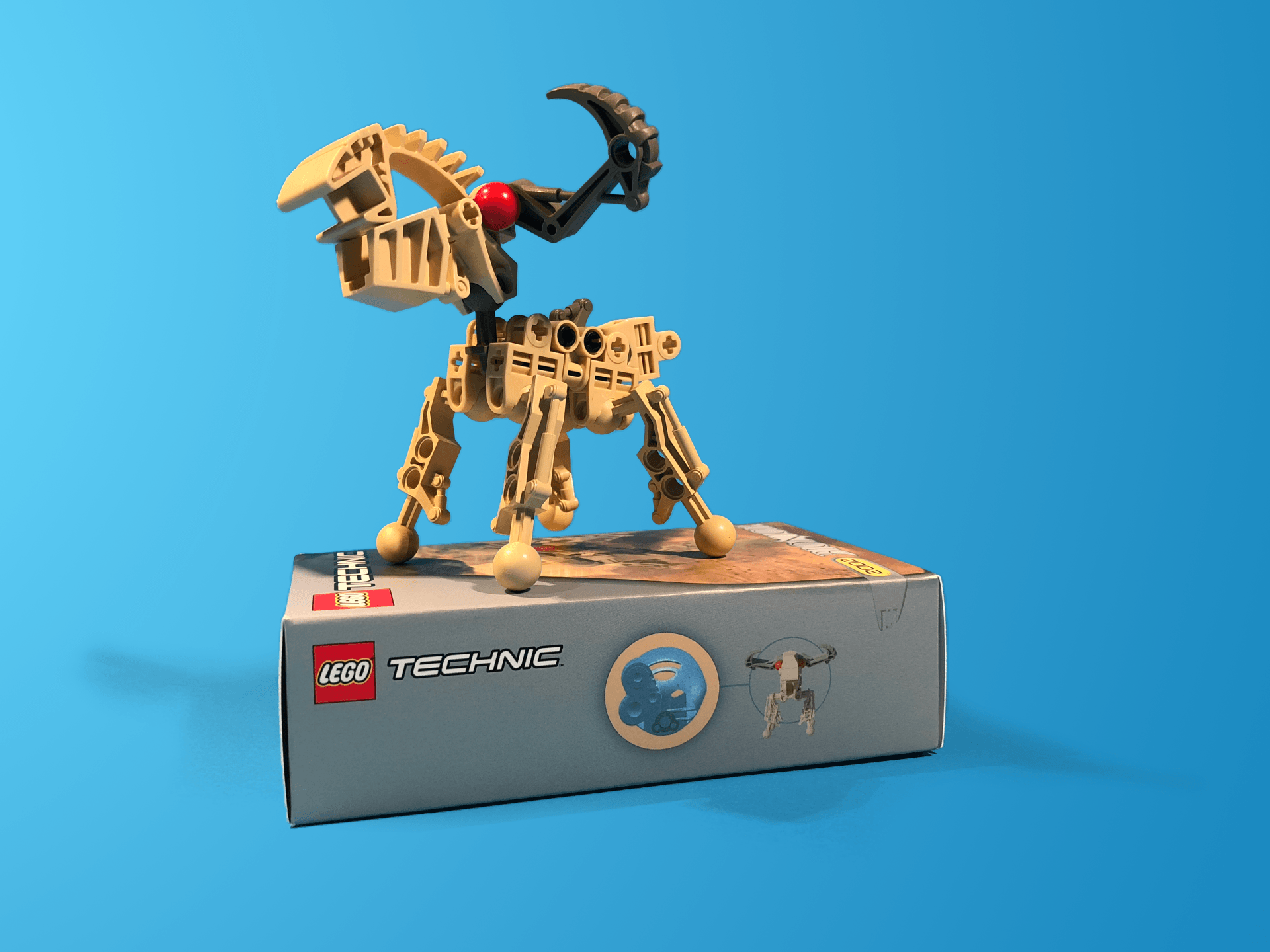A lego technic toy is sitting on top of a box
