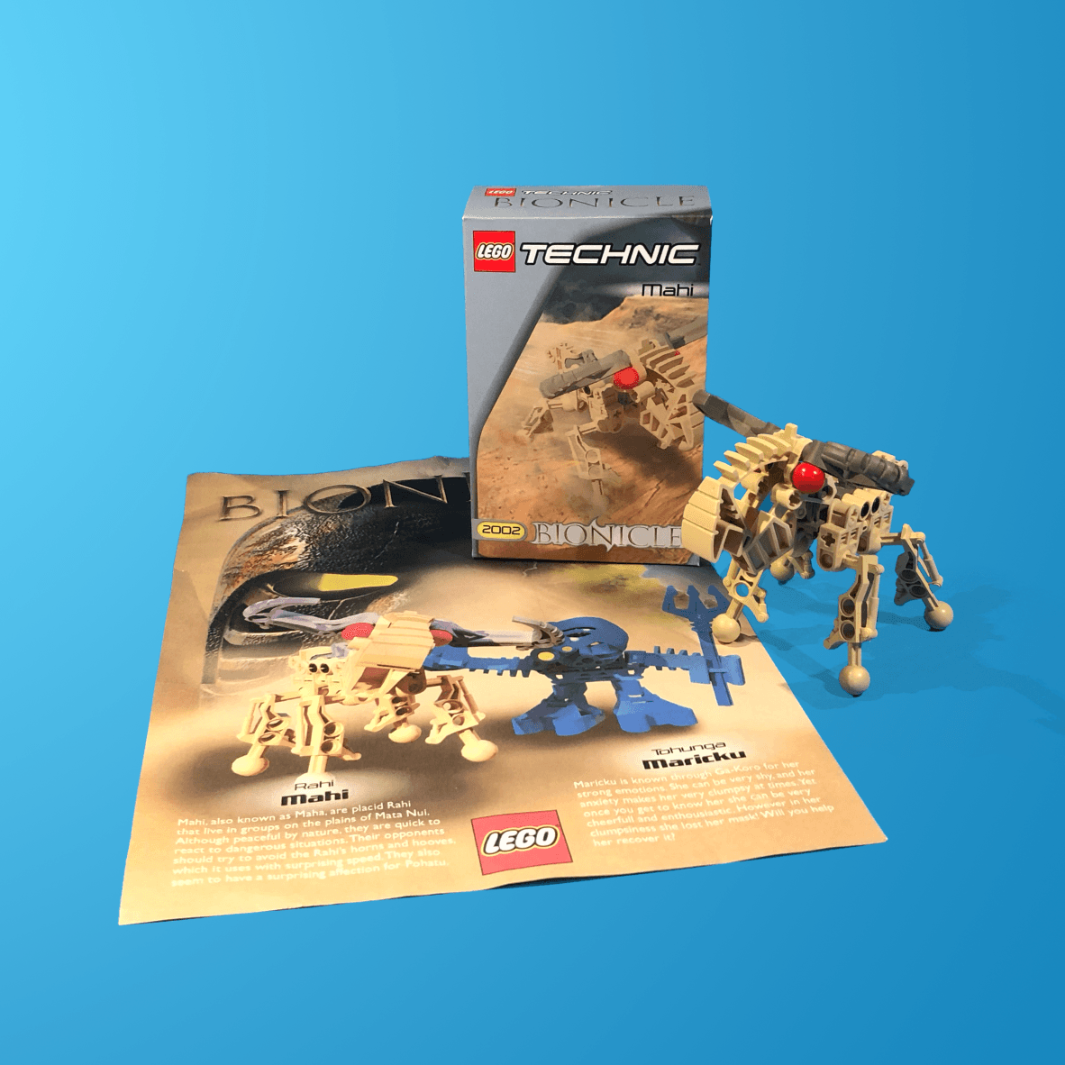 A lego technic set is sitting on a blue surface