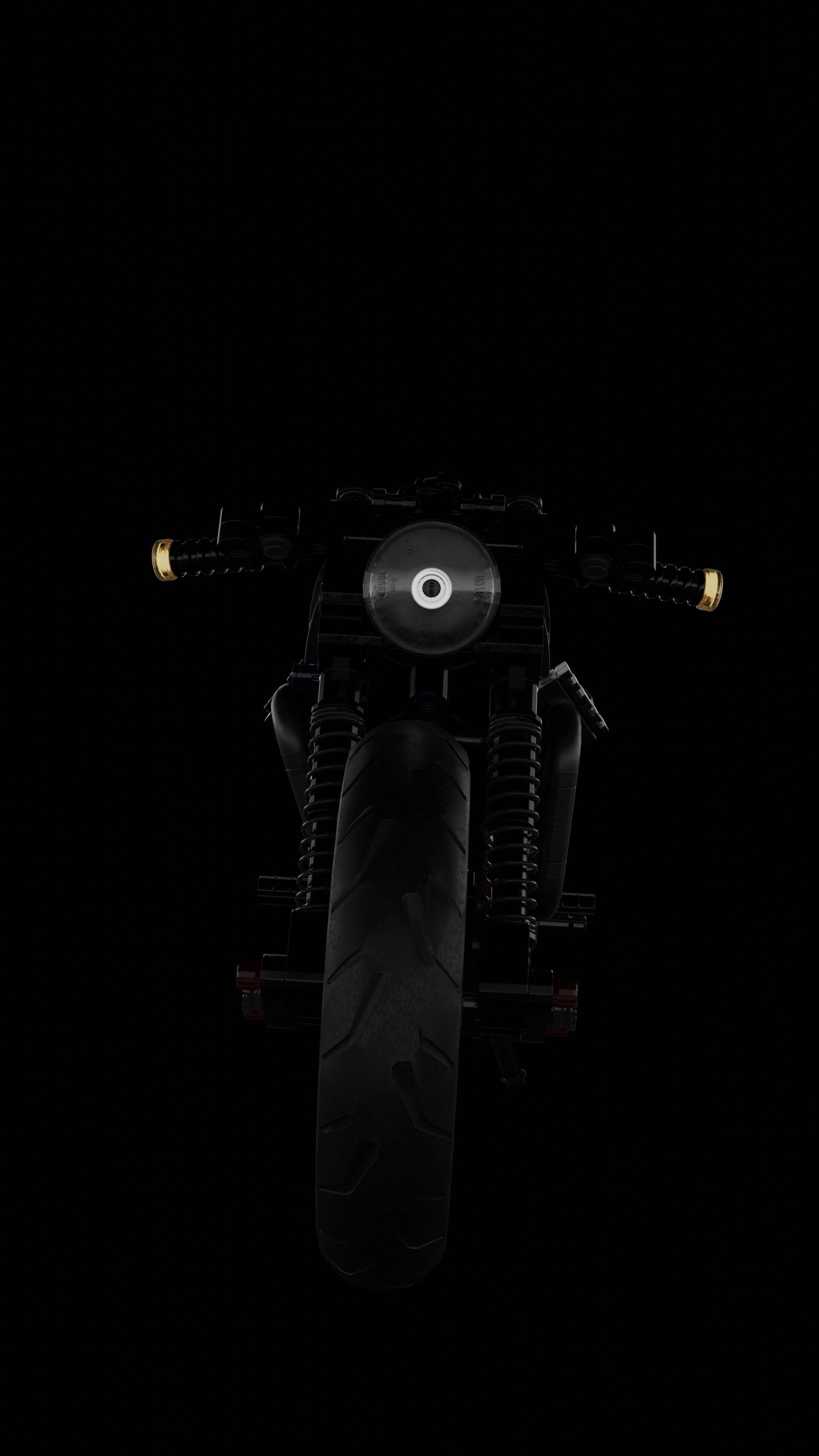 The front of a motorcycle is lit up in the dark.