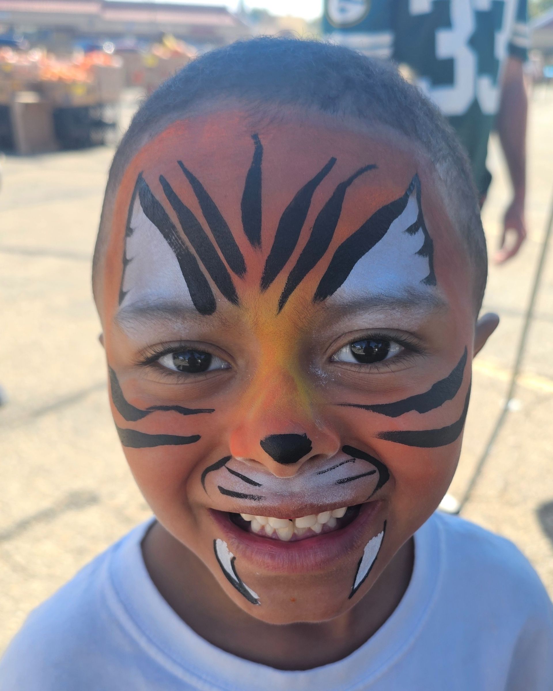 Full face painted ornage and white tiger.