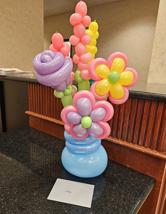 Floral Balloon Bouquet. Assortment of balloon twisted flowers. Specialty add-on such as a helium balloon is optional. Includes hand written message. 
