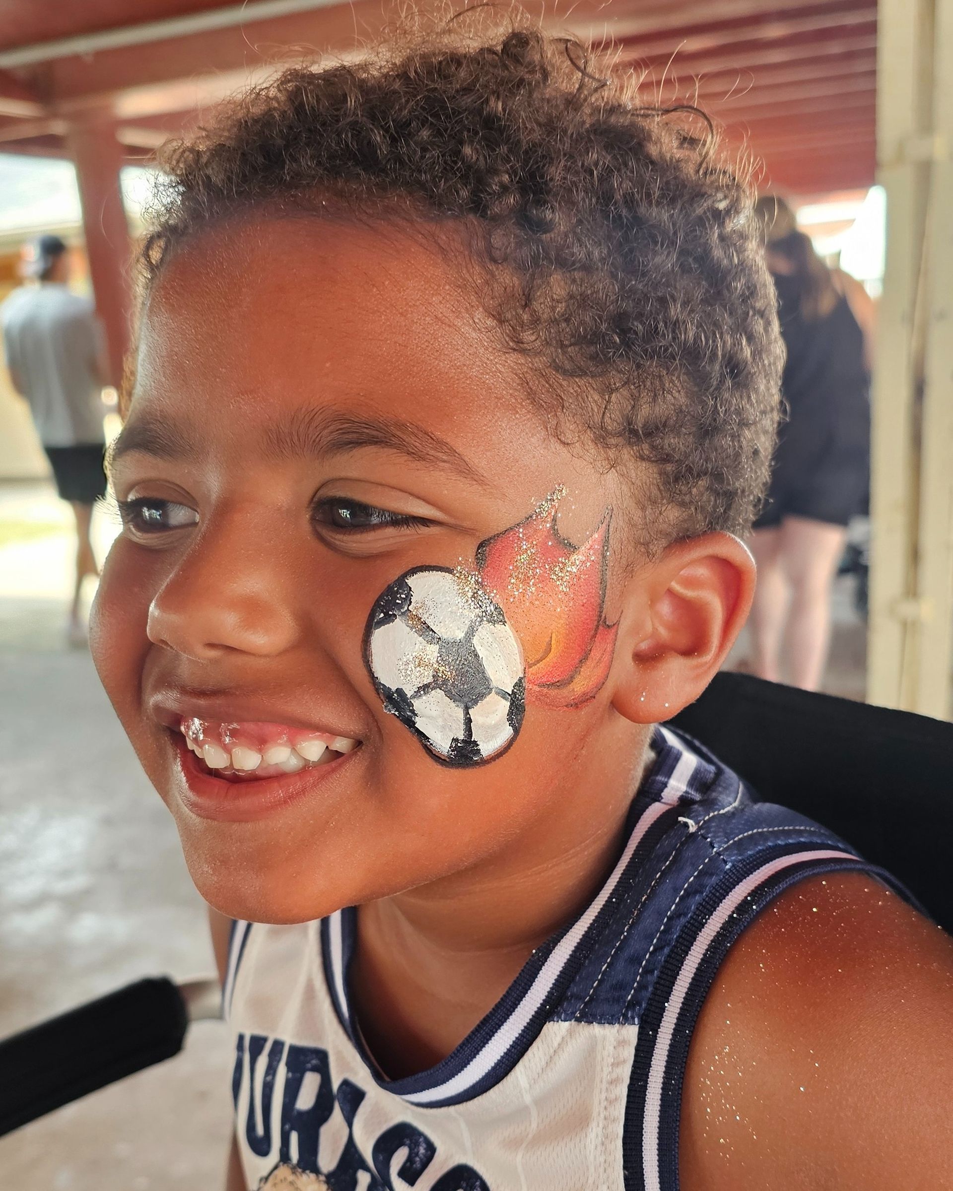 Black and white soccer ball with red orange flames and a touch of sparkle on side of face. 
