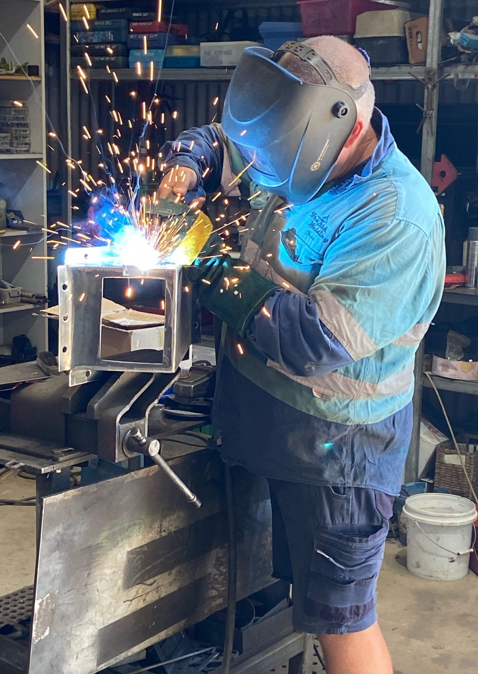 A Man Wearing a Welding Mask is Welding a Piece of Metal — Welders In Gilgandra, NSW