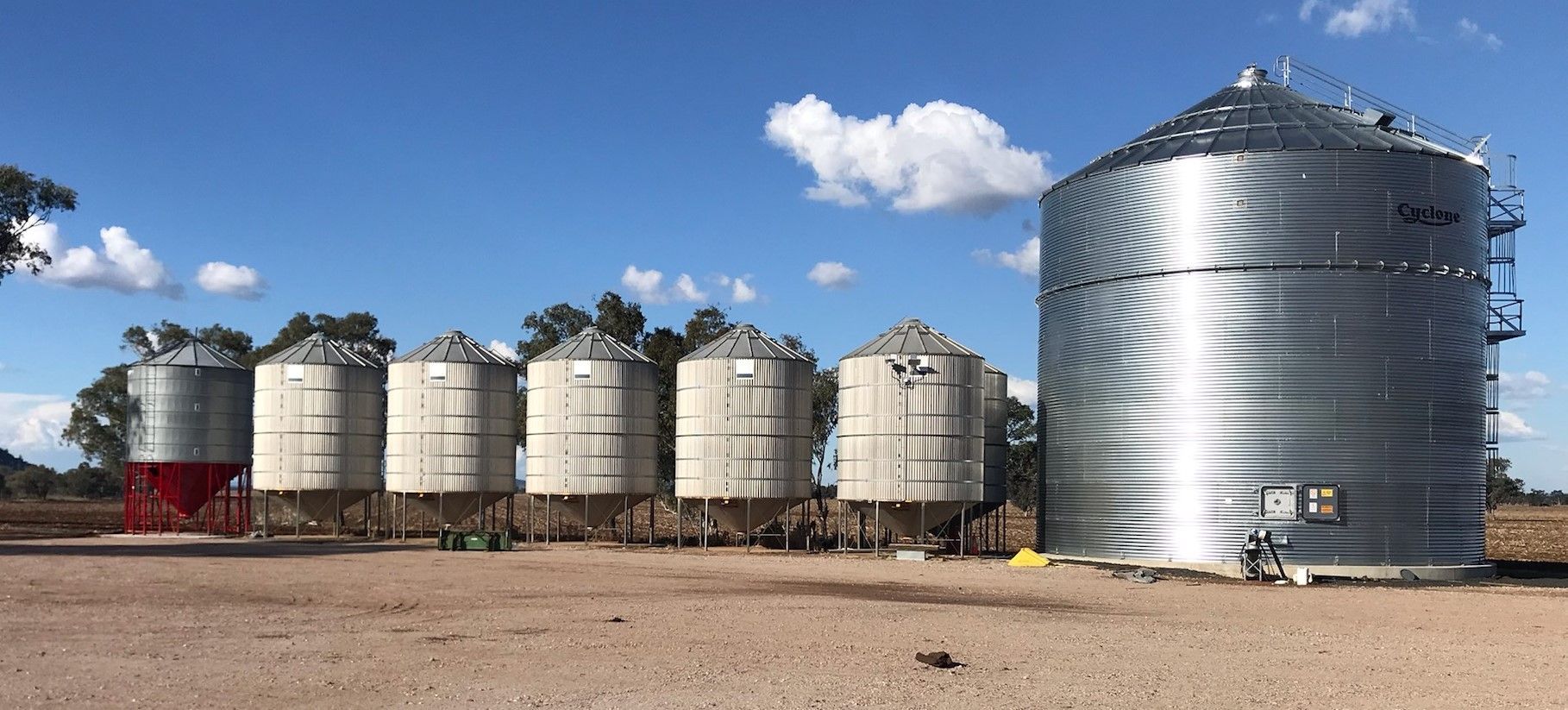 A Row of Silos Are Lined Up in a Dirt Field — Welders In Gilgandra, NSW
