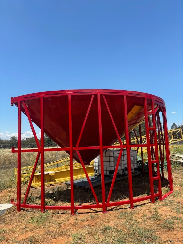 A Large Red Metal Structure is Sitting in the Middle of a Field — Welders In Gilgandra, NSW