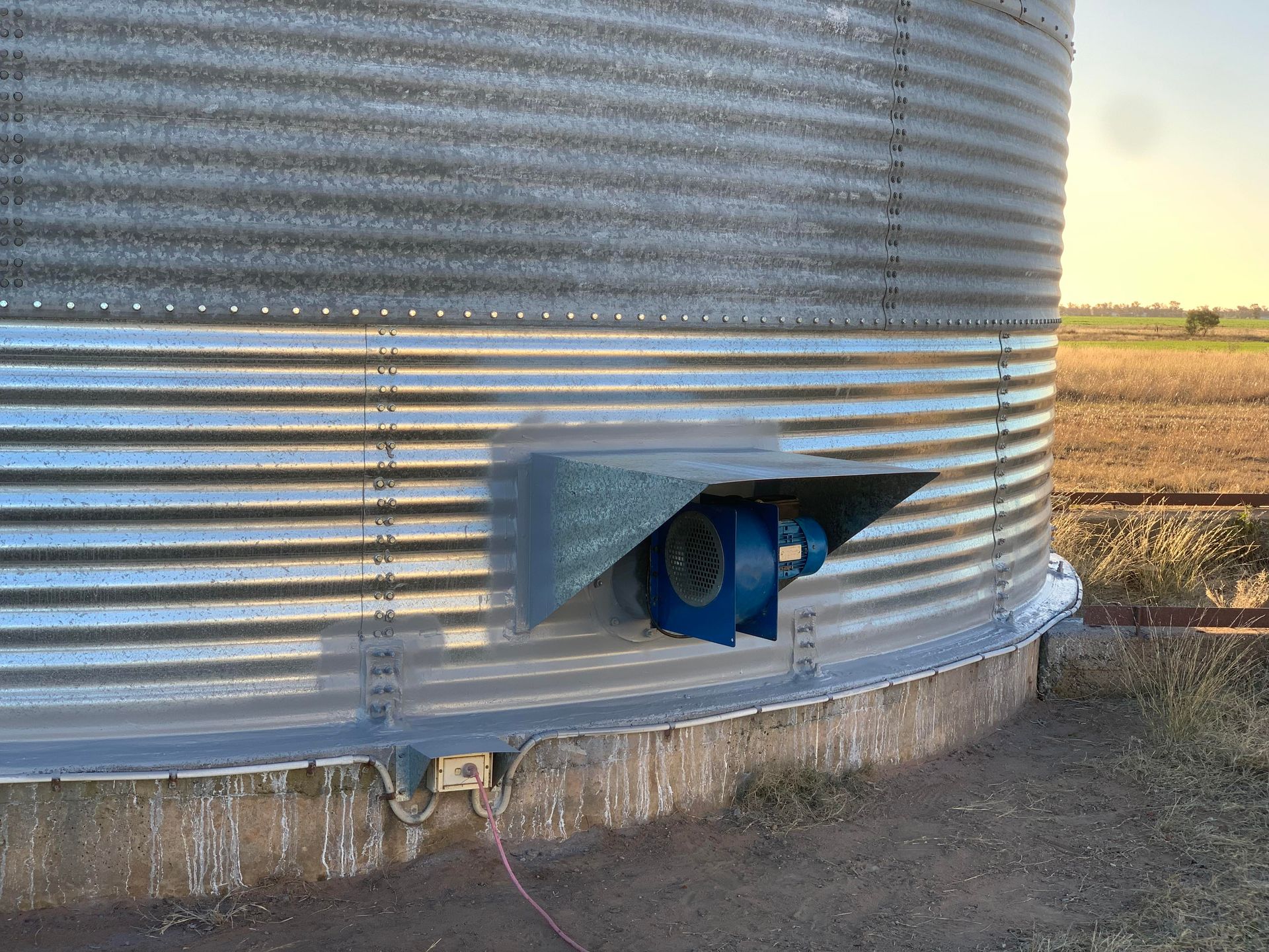 A Metal Silo With a Fan Attached to the Side of It — Welders In Gilgandra, NSW