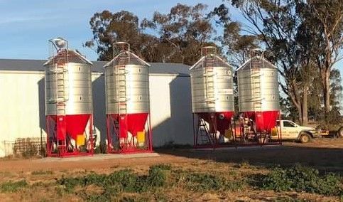 Three Silos Are Lined Up in a Field in Front of a Building — Welders In Gilgandra, NSW
