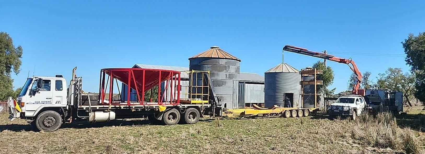 A Truck is Driving Through a Field With a Crane Attached to It — Welders In Gilgandra, NSW