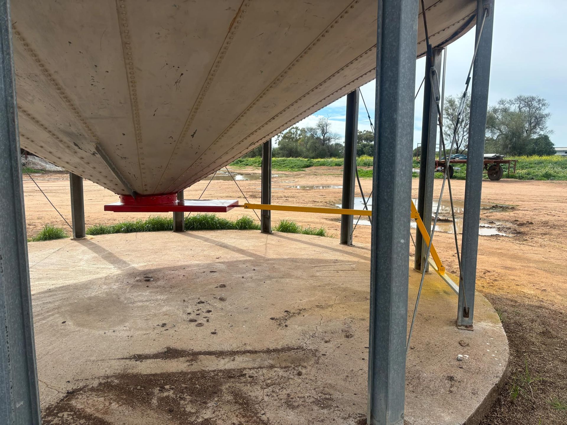 A Large Silo is Sitting in the Middle of a Dirt Field — Welders In Gilgandra, NSW