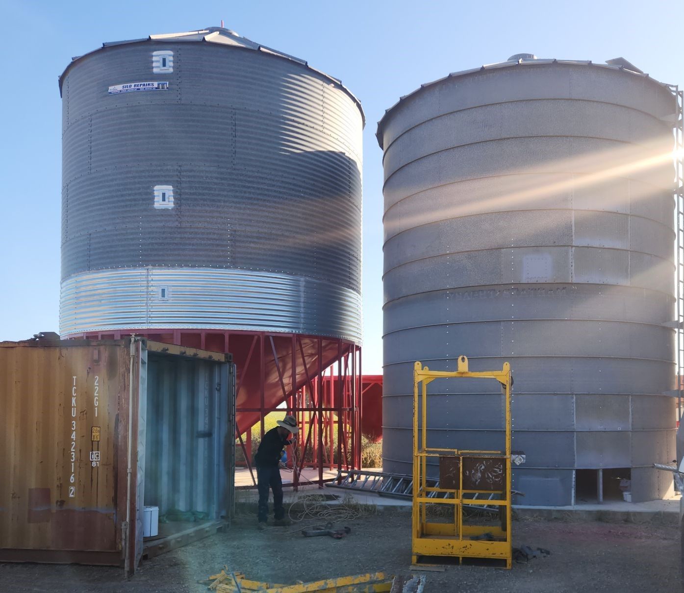 A Man is Standing in Front of Two Silos With the Letter a on Them — Welders In Gilgandra, NSW