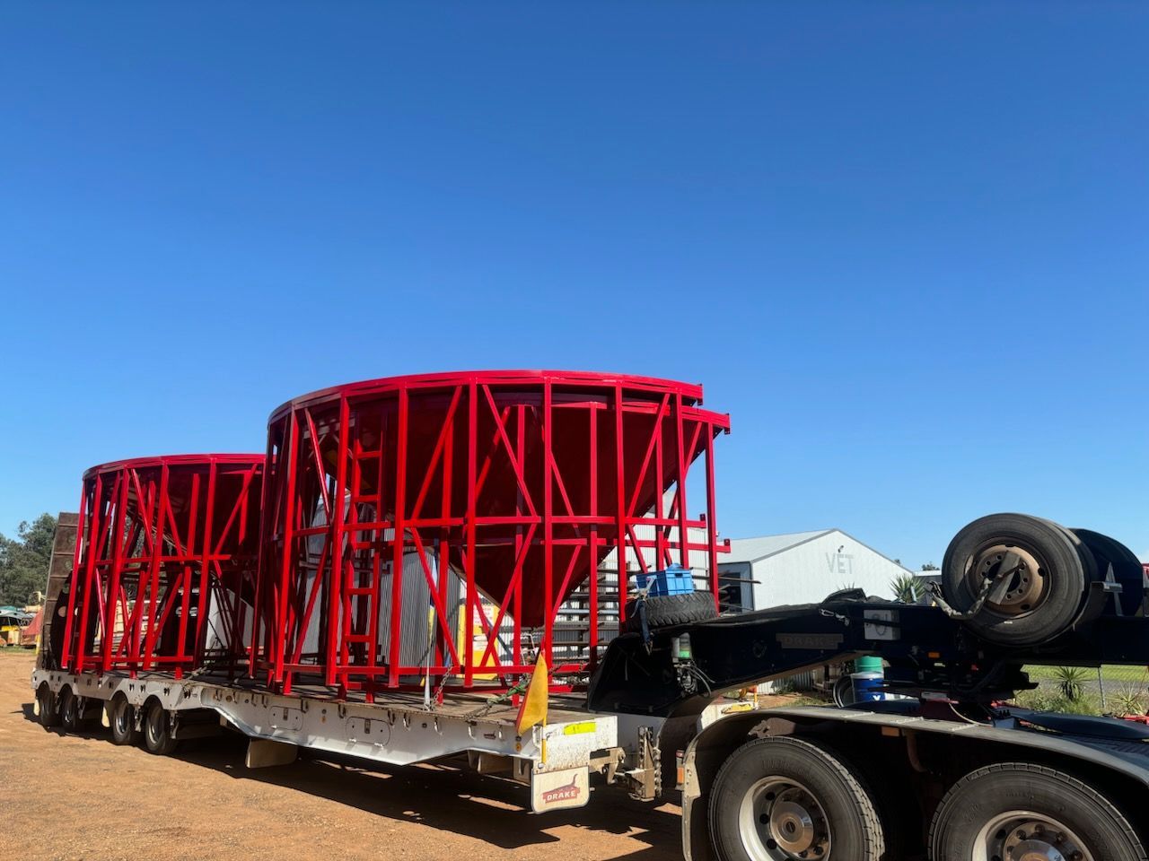 A Truck is Carrying a Large Red Structure on a Trailer — Welders In Gilgandra, NSW