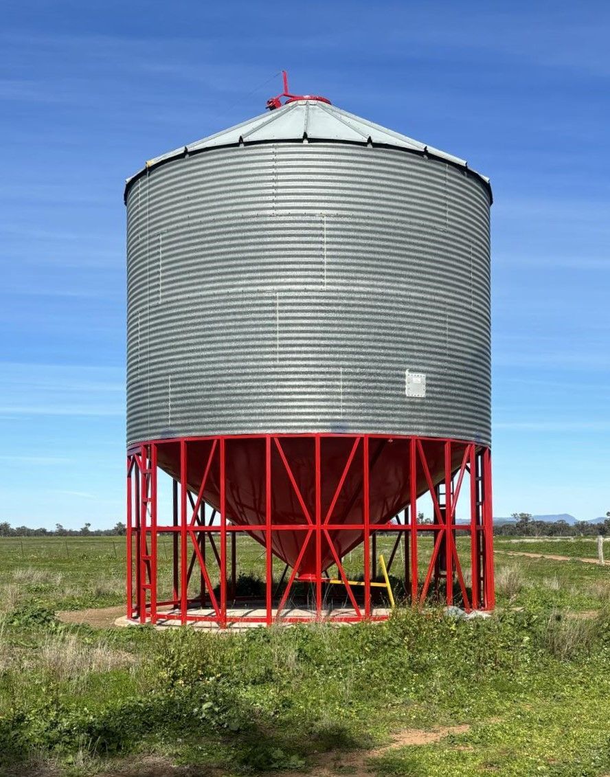 A Large Silo is Sitting in the Middle of a Grassy Field — Welders In Gilgandra, NSW