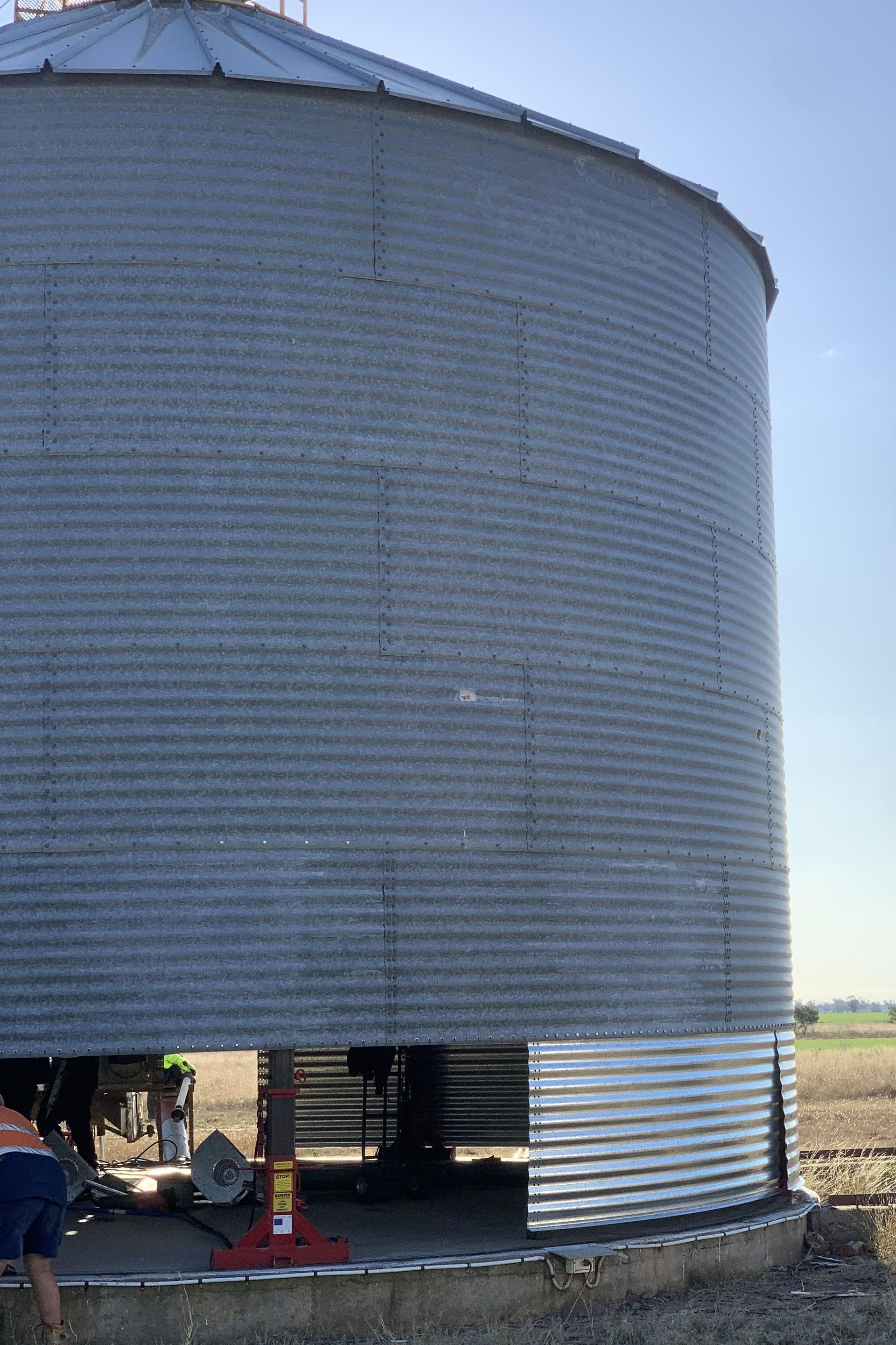 A Large Metal Silo is Sitting in the Middle of a Field — Welders In Gilgandra, NSW