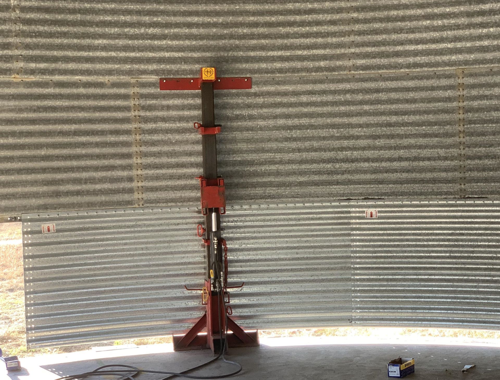 A Red and Black Object is Sitting in Front of a Metal Wall — Welders In Gilgandra, NSW