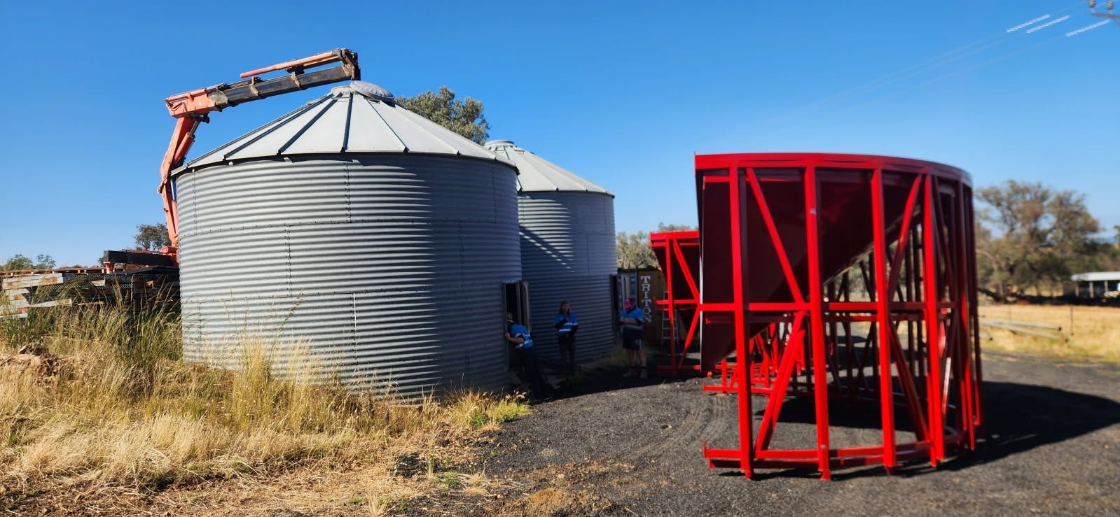 A Group of Silos Are Sitting Next to Each Other in a Field — Welders In Gilgandra, NSW