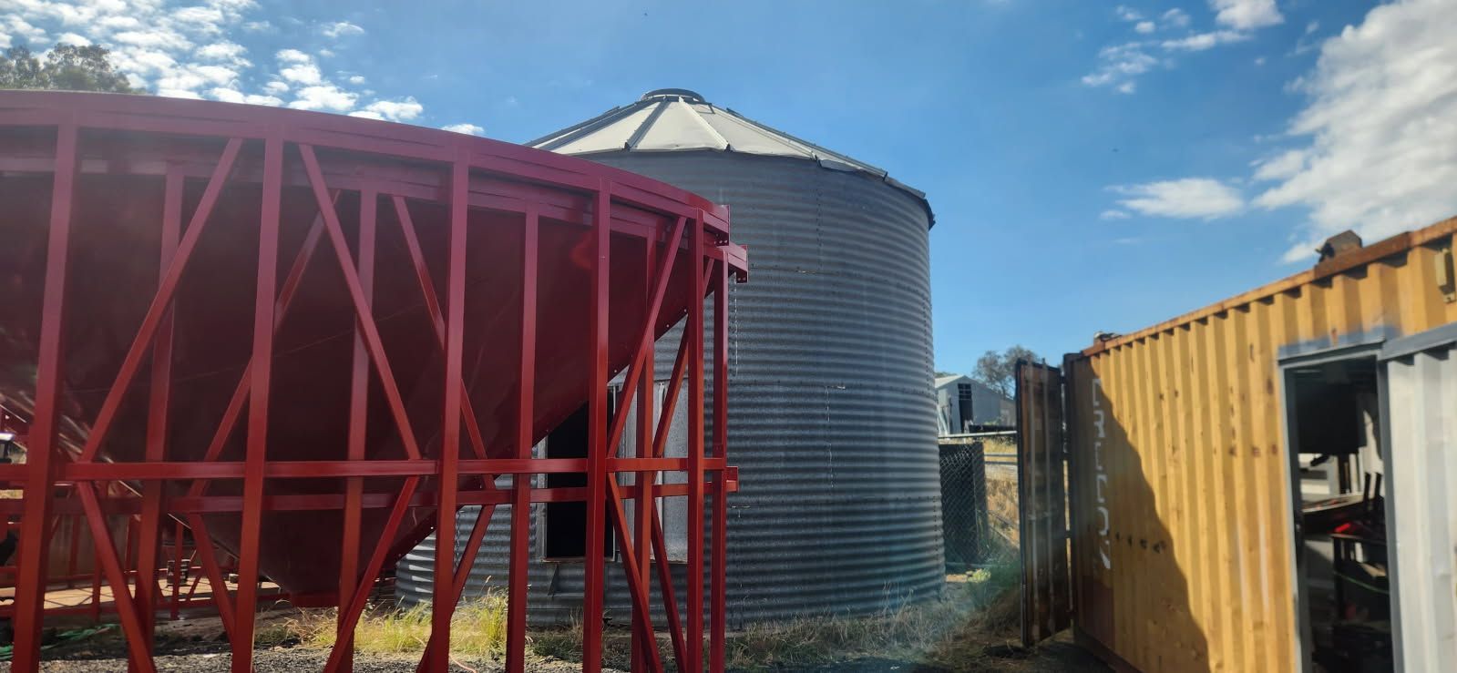 A Large Red Structure is Sitting Next to a Large Silo — Welders In Gilgandra, NSW